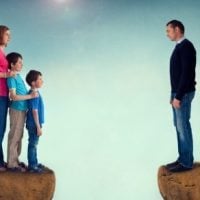 Father standing apart from family Father standing apart from family